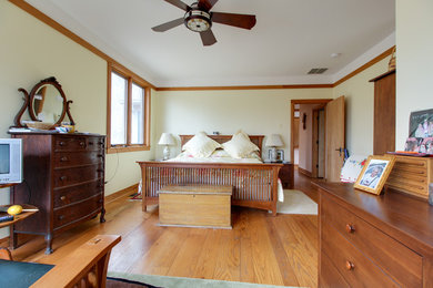 Bedroom - mid-sized transitional guest medium tone wood floor and brown floor bedroom idea in Other with white walls