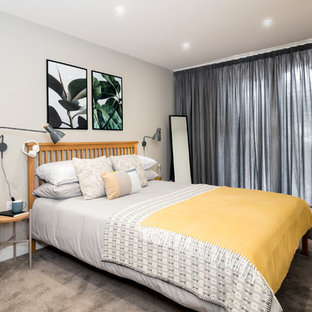 Photo of a medium sized contemporary guest bedroom in Hampshire with carpet, grey floors and grey walls.