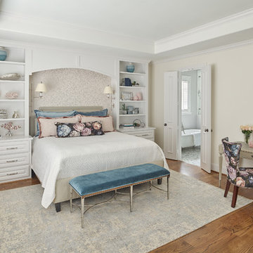 Feminine Master Bedroom with Built-in Bookshelves and Swing Arm Sconces