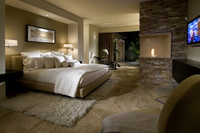 Inspiration for a large master bedroom in New Orleans with beige walls, ceramic flooring and a corner fireplace.