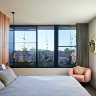 Contemporary guest bedroom in Melbourne with white walls.