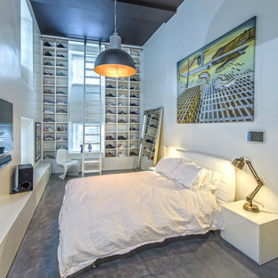 Foto de dormitorio industrial, de tamaño medio, con paredes blancas, suelo de cemento y suelo gris