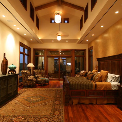Example of an eclectic dark wood floor bedroom design in Dallas with beige walls
