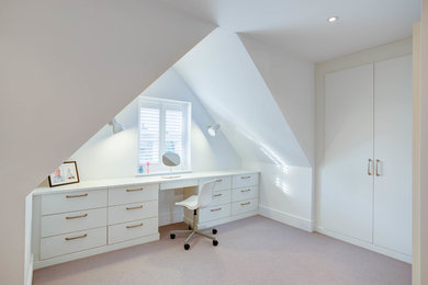 Inspiration for a contemporary master bedroom in Surrey with white walls and carpet.