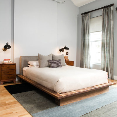 Example of a large eclectic master light wood floor bedroom design in New York with gray walls and no fireplace
