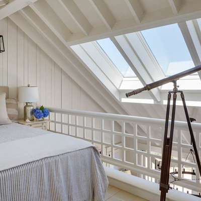 Inspiration for a mid-sized coastal loft-style bedroom remodel in Boston with white walls and no fireplace