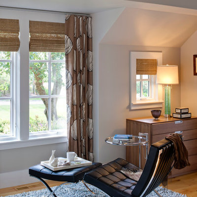 Example of a large trendy master light wood floor and brown floor bedroom design in Boston with gray walls