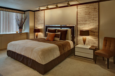 This is an example of a large contemporary master bedroom in New York with beige walls and carpet.