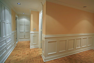 Example of a mid-sized transitional master light wood floor bedroom design in New York with beige walls and no fireplace