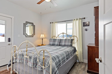 Mid-sized cottage guest bedroom photo in Other with gray walls