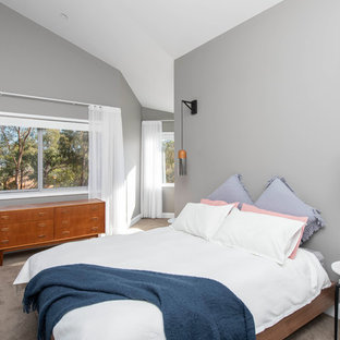 This is an example of a contemporary master bedroom in Canberra - Queanbeyan with grey walls, carpet and grey floor.