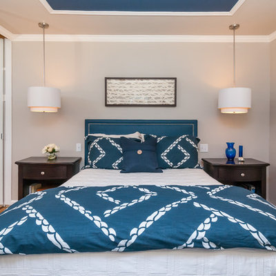 Mid-sized transitional master medium tone wood floor bedroom photo in San Francisco with beige walls and no fireplace