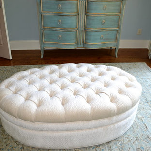 Mid-sized victorian master bedroom in Charlotte with blue walls, light hardwood floors, no fireplace and brown floor.