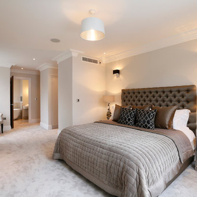 Example of a trendy master carpeted bedroom design in London with gray walls
