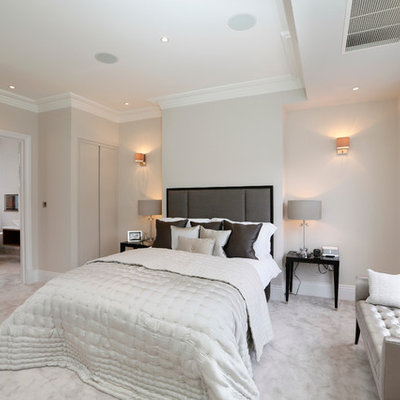 Trendy master carpeted and gray floor bedroom photo in London with gray walls