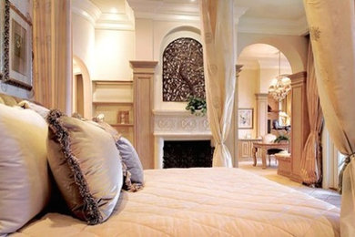 Example of a large trendy master bedroom design in Vancouver with white walls and a standard fireplace