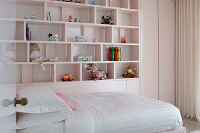 Photo of a medium sized contemporary master bedroom in London with pink walls.