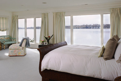 This is an example of a large classic master bedroom in New York with white walls, carpet, no fireplace and white floors.