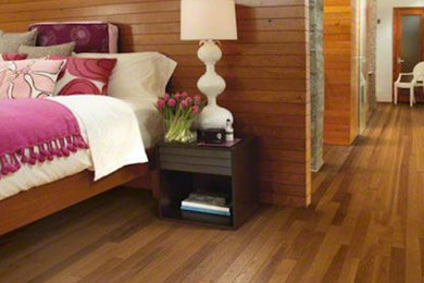 Inspiration for a mid-sized transitional medium tone wood floor bedroom remodel in San Diego with no fireplace