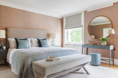 Inspiration for a contemporary master bedroom in London with beige walls, medium hardwood flooring and no fireplace.