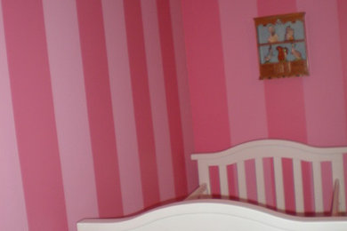 Eclectic bedroom photo in Minneapolis with pink walls