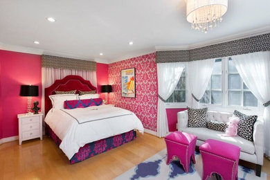 Design ideas for a medium sized bohemian master bedroom in Los Angeles with pink walls and light hardwood flooring.