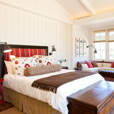 Example of a classic medium tone wood floor bedroom design in San Francisco with white walls