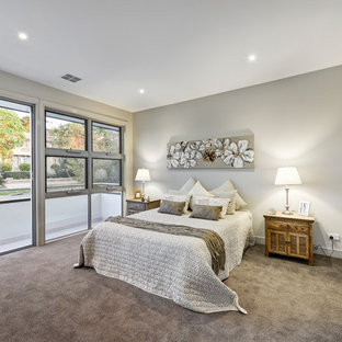 Design ideas for a mid-sized contemporary master bedroom in Melbourne with carpet, grey walls, no fireplace and grey floor.
