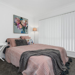 This is an example of a beach style guest bedroom in Gold Coast - Tweed with white walls, carpet and grey floor.