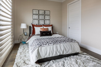 Inspiration for a mid-sized transitional guest medium tone wood floor and brown floor bedroom remodel in Denver with beige walls and no fireplace