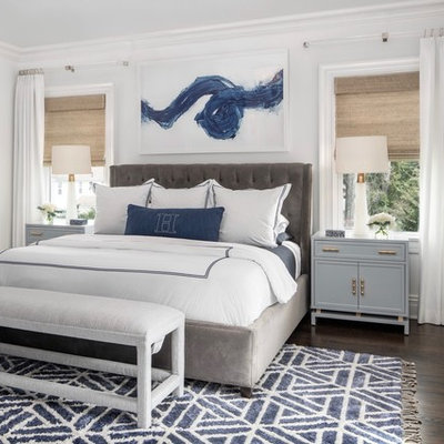 Example of a beach style master dark wood floor bedroom design in New York with white walls and no fireplace
