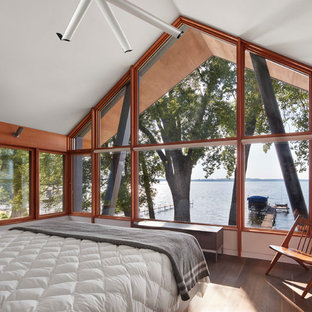 Example of a mountain style master brown floor and medium tone wood floor bedroom design in Minneapolis with white walls