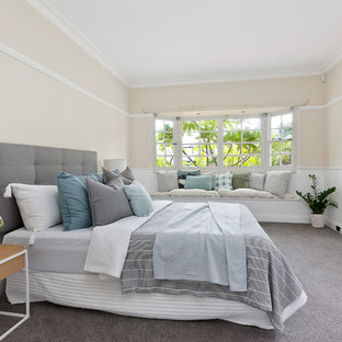 Photo of a large transitional master bedroom in Sydney with carpet, grey floor, beige walls and no fireplace.