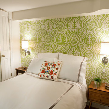 guest bedroom with accent wall and custom lighting