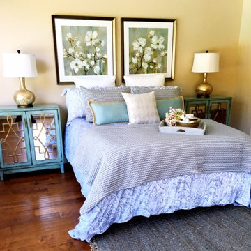Guest bedroom with blue accents and flower art