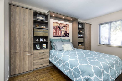 This is an example of a medium sized contemporary guest bedroom with white walls, medium hardwood flooring, no fireplace and brown floors.