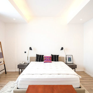 Bedroom - modern guest light wood floor and beige floor bedroom idea in Los Angeles with white walls