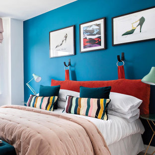 Contemporary bedroom in London with blue walls.