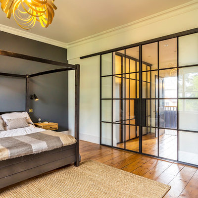 Bedroom - mid-sized contemporary master medium tone wood floor and brown floor bedroom idea in Surrey with multicolored walls
