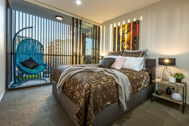 This is an example of a contemporary bedroom in Brisbane with carpet.