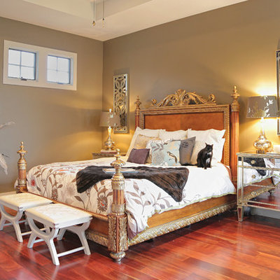 Eclectic medium tone wood floor bedroom photo in Austin with beige walls