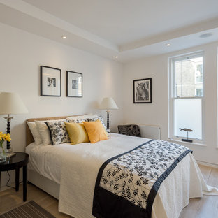 Design ideas for a medium sized classic bedroom in London with white walls and light hardwood flooring.