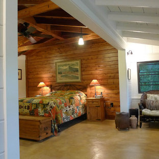 Traditional bedroom in Miami with concrete floors and yellow floor.