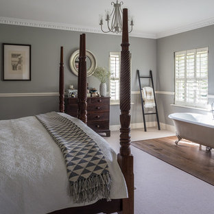 Photo of a medium sized traditional bedroom in London with grey walls, carpet and beige floors.