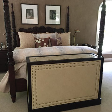 Hand made unique leather cabinet with lift hides the TV in the bedroom & keeps e