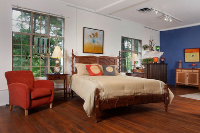 Example of a large trendy medium tone wood floor and brown floor bedroom design in Other with white walls and no fireplace