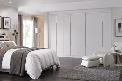 Design ideas for a large contemporary master bedroom in London with grey walls and dark hardwood flooring.