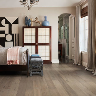 Inspiration for a large transitional guest medium tone wood floor and brown floor bedroom remodel in Phoenix with beige walls and no fireplace