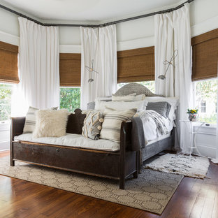Example of a mid-sized southwest master dark wood floor and brown floor bedroom design in Houston with white walls