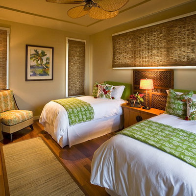 Example of an island style guest dark wood floor bedroom design in Hawaii with gray walls